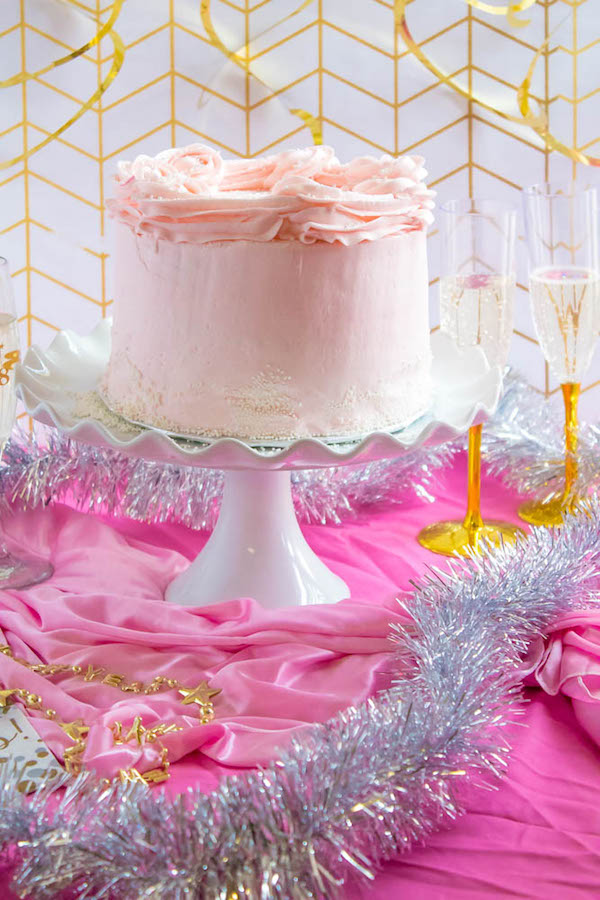 This Pink Champagne Cake is the perfect way to celebrate New Years Eve. Layers of Champagne infused cake, filled with a Champagne infused Buttercream and frosted with a light and fluffy vanilla buttercream — there's no better way to start the new year!