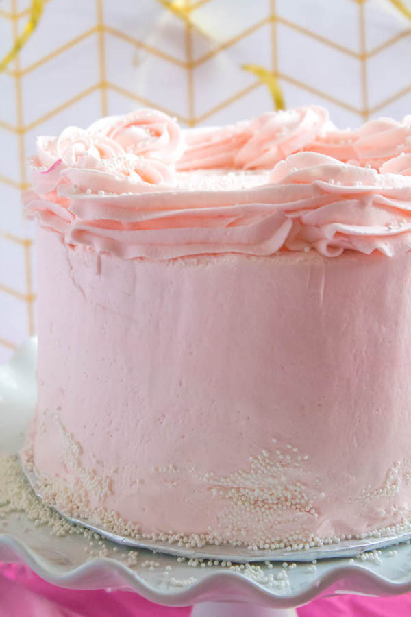 This Pink Champagne Cake is the perfect way to celebrate New Years Eve. Layers of Champagne infused cake, filled with a Champagne infused Buttercream and frosted with a light and fluffy vanilla buttercream — there's no better way to start the new year!