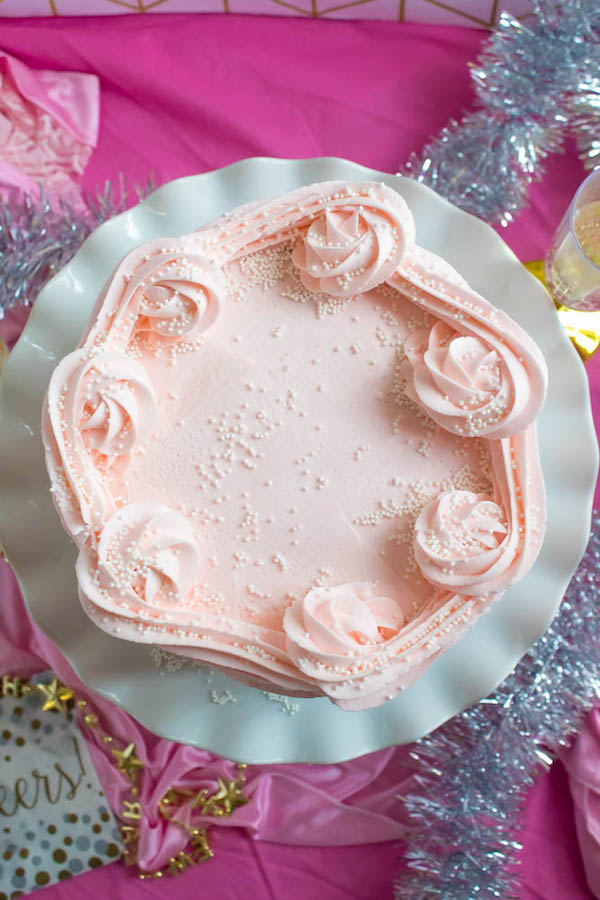 This Pink Champagne Cake is the perfect way to celebrate New Years Eve. Layers of Champagne infused cake, filled with a Champagne infused Buttercream and frosted with a light and fluffy vanilla buttercream — there's no better way to start the new year!