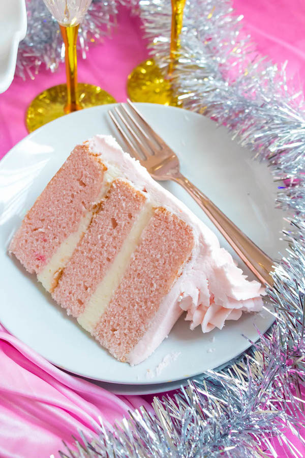 This Pink Champagne Cake is the perfect way to celebrate New Years Eve. Layers of Champagne infused cake, filled with a Champagne infused Buttercream and frosted with a light and fluffy vanilla buttercream — there's no better way to start the new year!