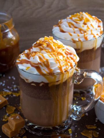 Salted Caramel Hot Chocolate - sweet and salty caramel hot chocolate, topped with sweetened whipped cream, salted caramel sauce and homemade salted caramel sugar! This is the perfect drink for warming up during the cold winter months.