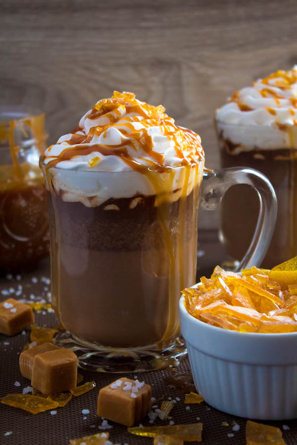 Salted Caramel Hot Chocolate - sweet and salty caramel hot chocolate, topped with sweetened whipped cream, salted caramel sauce and homemade salted caramel sugar! This is the perfect drink for warming up during the cold winter months.