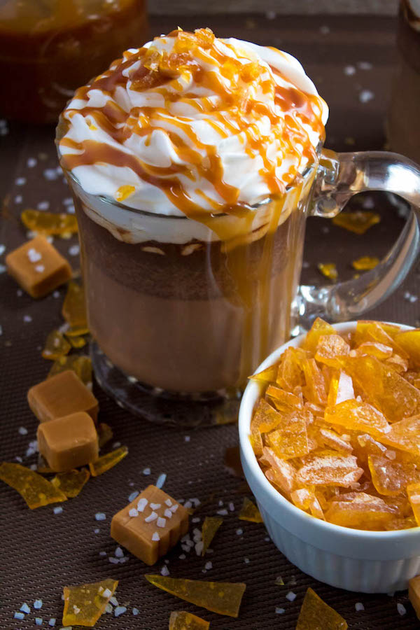 Salted Caramel Hot Chocolate - sweet and salty caramel hot chocolate, topped with sweetened whipped cream, salted caramel sauce and homemade salted caramel sugar! This is the perfect drink for warming up during the cold winter months.