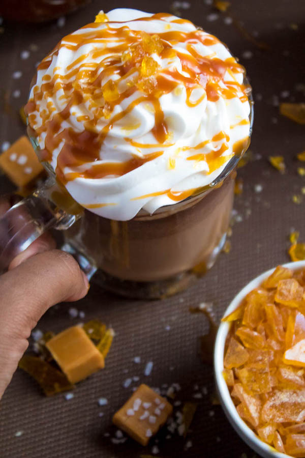 Salted Caramel Hot Chocolate - sweet and salty caramel hot chocolate, topped with sweetened whipped cream, salted caramel sauce and homemade salted caramel sugar! This is the perfect drink for warming up during the cold winter months.