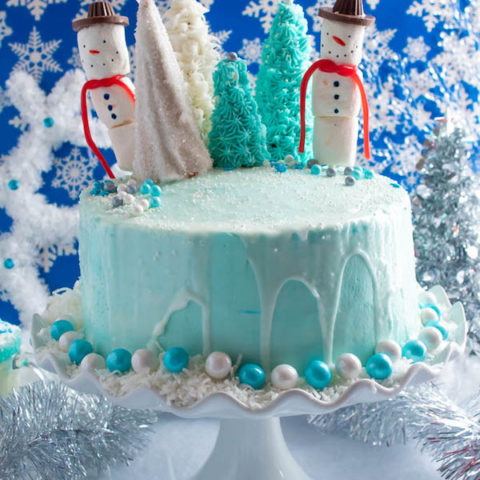 This Winter Wonderland Cake has all the magic and beauty of winter inside a cake! With a wintery white and blue theme, marshmallow snowmen, sugar cone Christmas trees and a powdered sugar snow drip, this is the perfect dessert for your Winter Wonderland themed party!