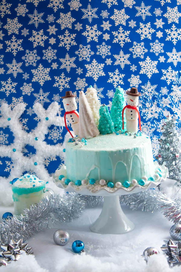 This Winter Wonderland Cake has all the magic and beauty of winter inside a cake! With a wintery white and blue theme, marshmallow snowmen, sugar cone Christmas trees and a powdered sugar snow drip, this is the perfect dessert for your Winter Wonderland themed party!