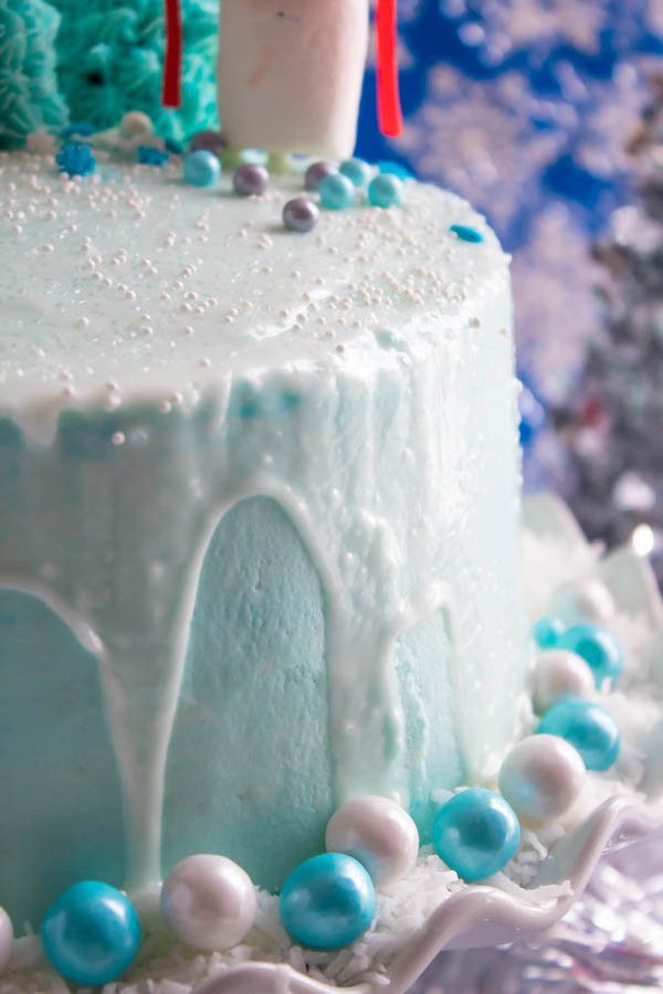 This Winter Wonderland Cake has all the magic and beauty of winter inside a cake! With a wintery white and blue theme, marshmallow snowmen, sugar cone Christmas trees and a powdered sugar snow drip, this is the perfect dessert for your Winter Wonderland themed party!