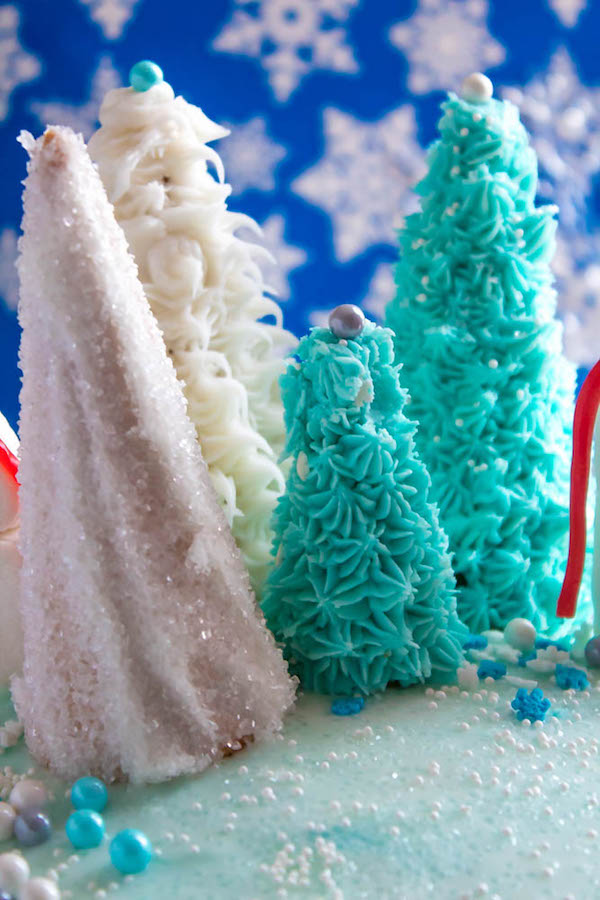 This Winter Wonderland Cake has all the magic and beauty of winter inside a cake! With a wintery white and blue theme, marshmallow snowmen, sugar cone Christmas trees and a powdered sugar snow drip, this is the perfect dessert for your Winter Wonderland themed party!