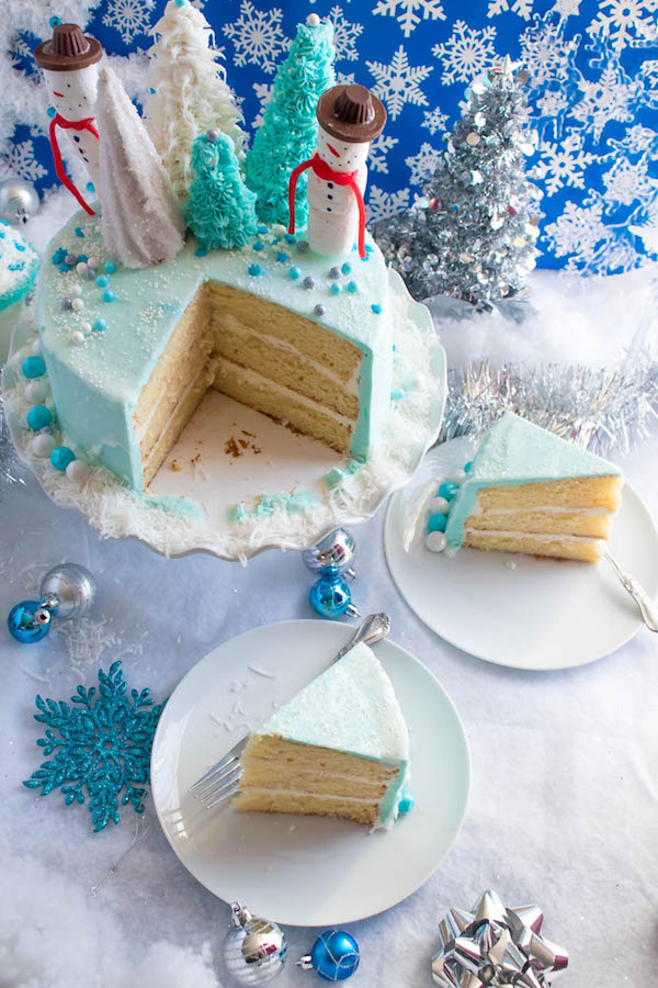 This Winter Wonderland Cake has all the magic and beauty of winter inside a cake! With a wintery white and blue theme, marshmallow snowmen, sugar cone Christmas trees and a powdered sugar snow drip, this is the perfect dessert for your Winter Wonderland themed party!