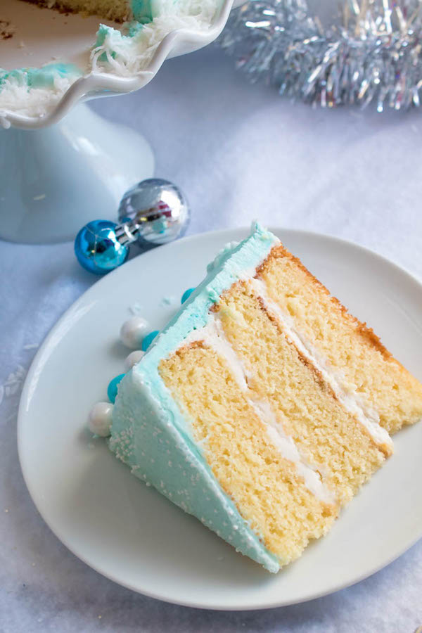 This Winter Wonderland Cake has all the magic and beauty of winter inside a cake! With a wintery white and blue theme, marshmallow snowmen, sugar cone Christmas trees and a powdered sugar snow drip, this is the perfect dessert for your Winter Wonderland themed party!