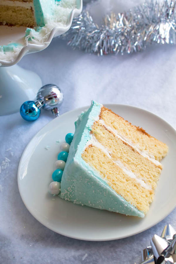 This Winter Wonderland Cake has all the magic and beauty of winter inside a cake! With a wintery white and blue theme, marshmallow snowmen, sugar cone Christmas trees and a powdered sugar snow drip, this is the perfect dessert for your Winter Wonderland themed party!