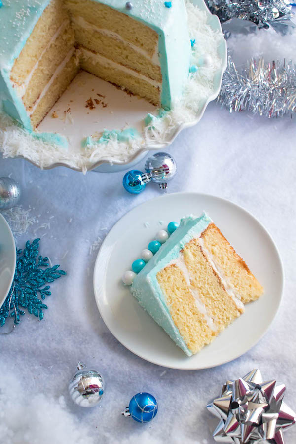 This Winter Wonderland Cake has all the magic and beauty of winter inside a cake! With a wintery white and blue theme, marshmallow snowmen, sugar cone Christmas trees and a powdered sugar snow drip, this is the perfect dessert for your Winter Wonderland themed party!