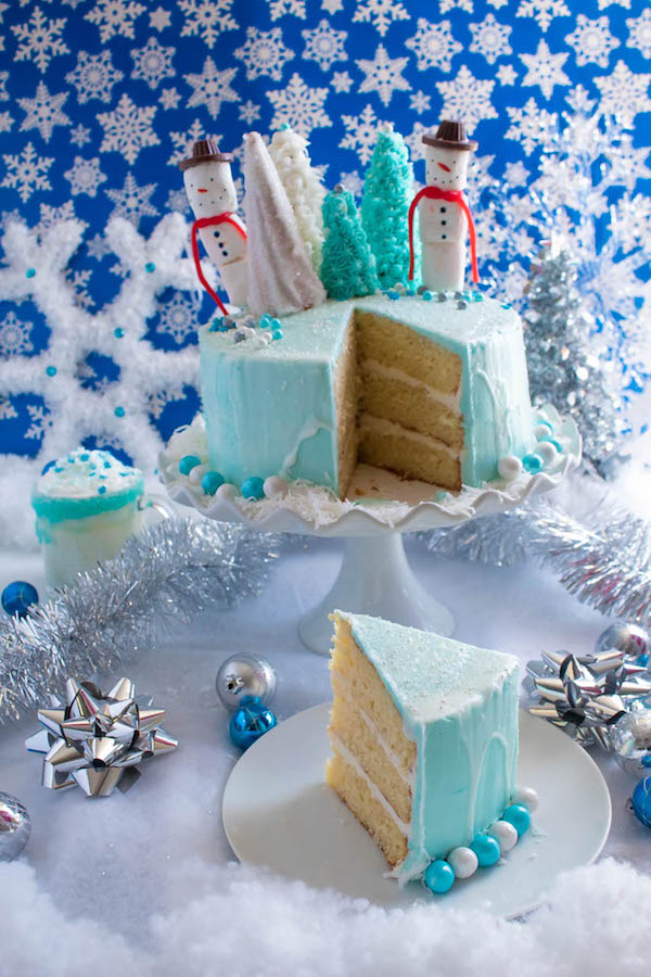 This Winter Wonderland Cake has all the magic and beauty of winter inside a cake! With a wintery white and blue theme, marshmallow snowmen, sugar cone Christmas trees and a powdered sugar snow drip, this is the perfect dessert for your Winter Wonderland themed party!