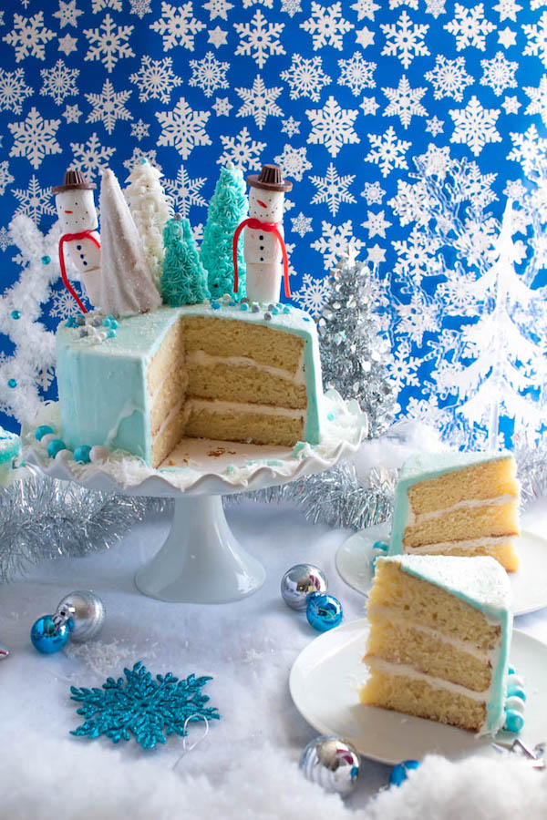 This Winter Wonderland Cake has all the magic and beauty of winter inside a cake! With a wintery white and blue theme, marshmallow snowmen, sugar cone Christmas trees and a powdered sugar snow drip, this is the perfect dessert for your Winter Wonderland themed party!