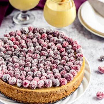 eggnog cheesecake covered with sugared cranberries