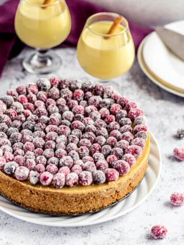 eggnog cheesecake covered with sugared cranberries