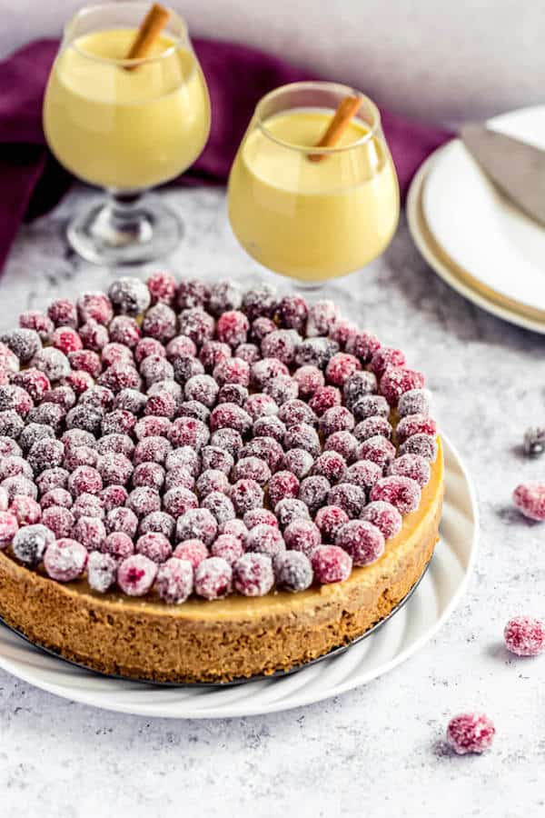 eggnog cheesecake covered with sugared cranberries 