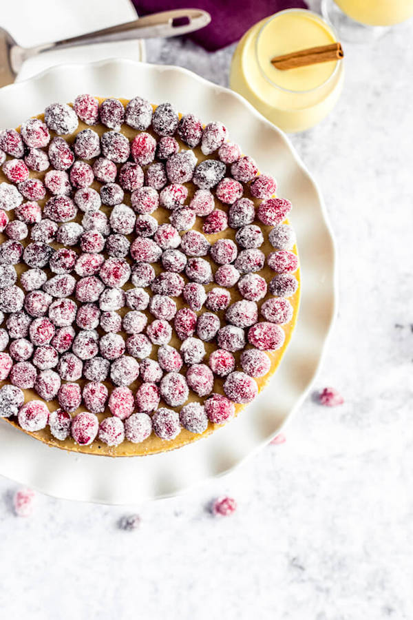 top view of eggnog cheesecake topped with sugared cranberries