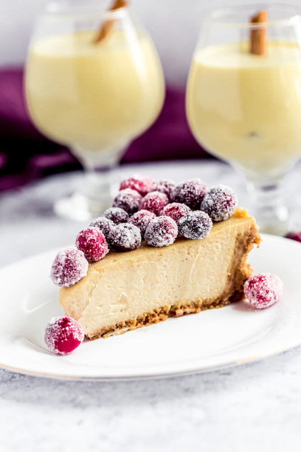 slice of eggnog cheesecake with sugared cranberries on top