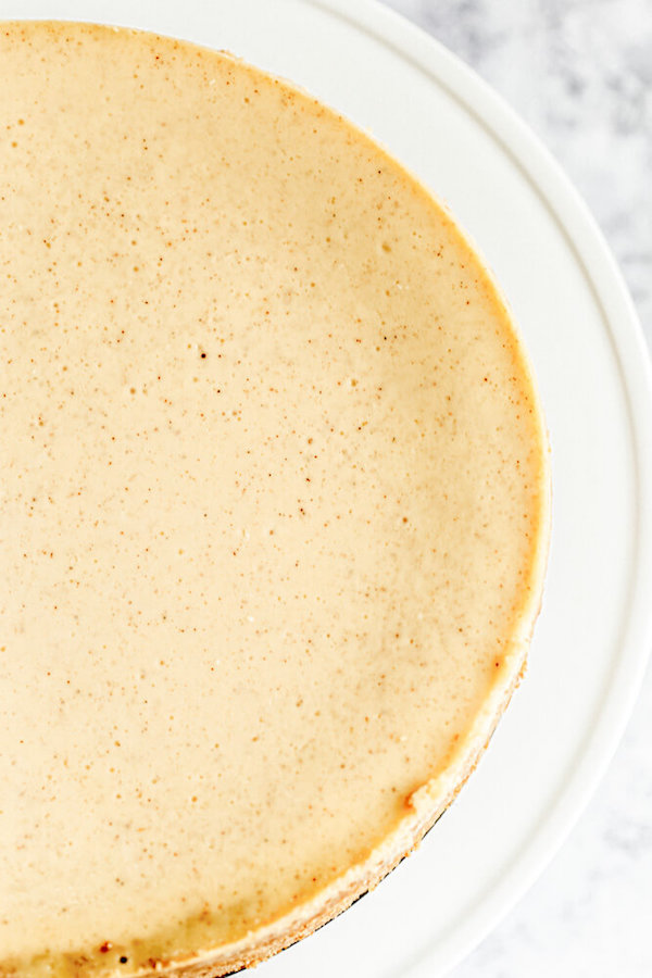 half shot of undecorated eggnog cheesecake