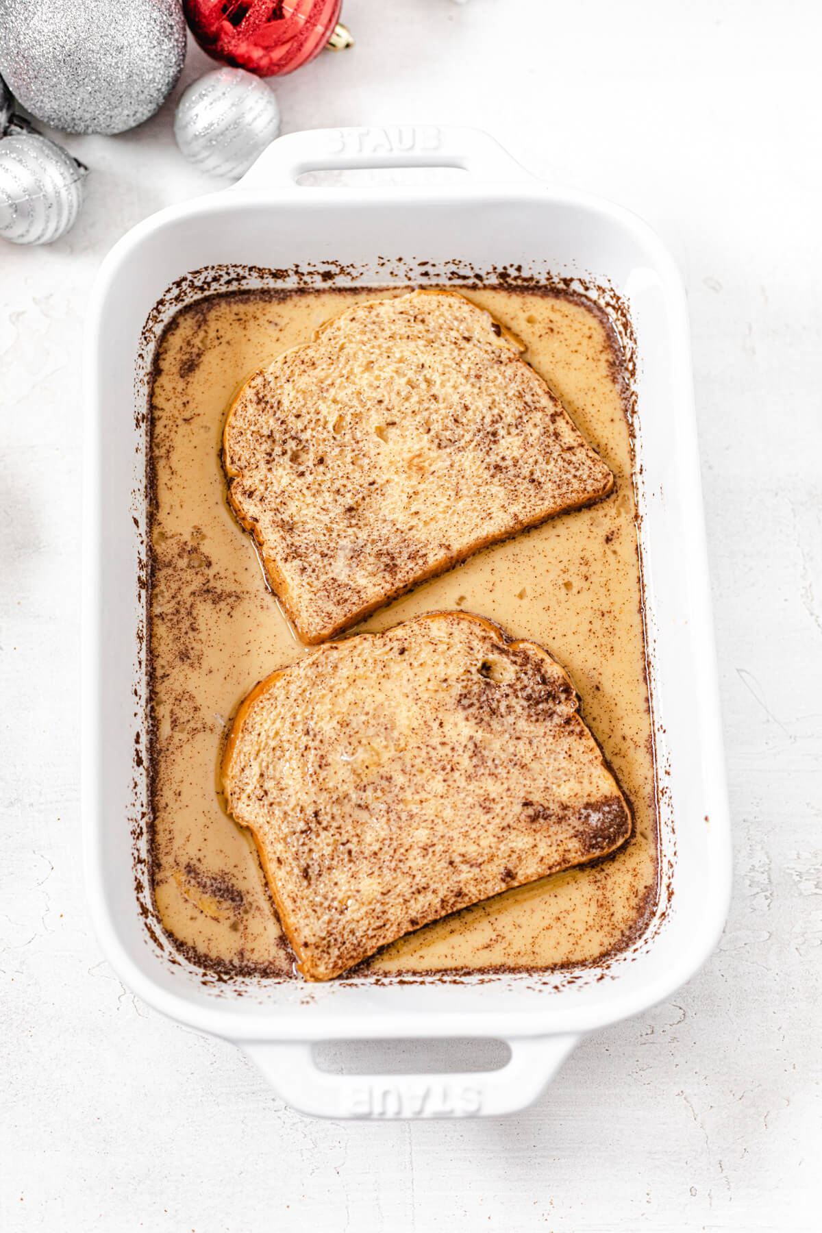 two slices of brioche bread in eggnog egg mixture