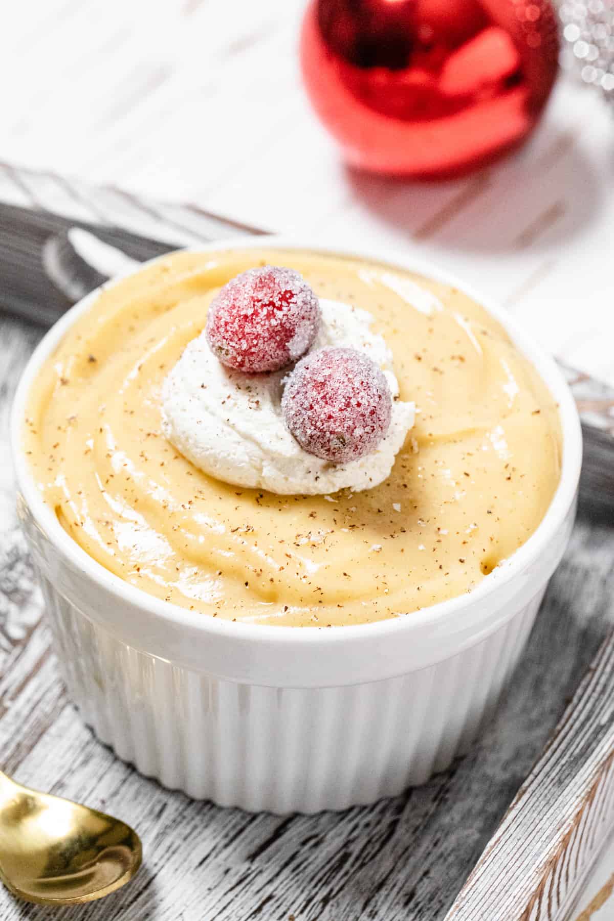 close up of pudding topped with sugared cranberries