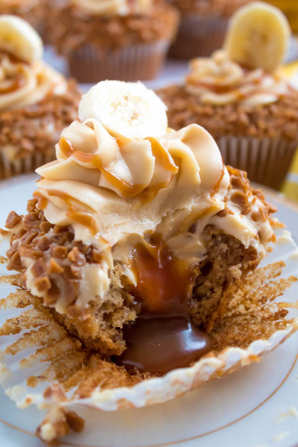 These Banana Caramel Cupcakes are moist, fluffy, tender and have the most perfect banana flavour! Filled with homemade caramel sauce, rolled in toffee bits and topped with Caramel Cream Cheese Frosting — these cupcakes will have your taste buds going crazy!