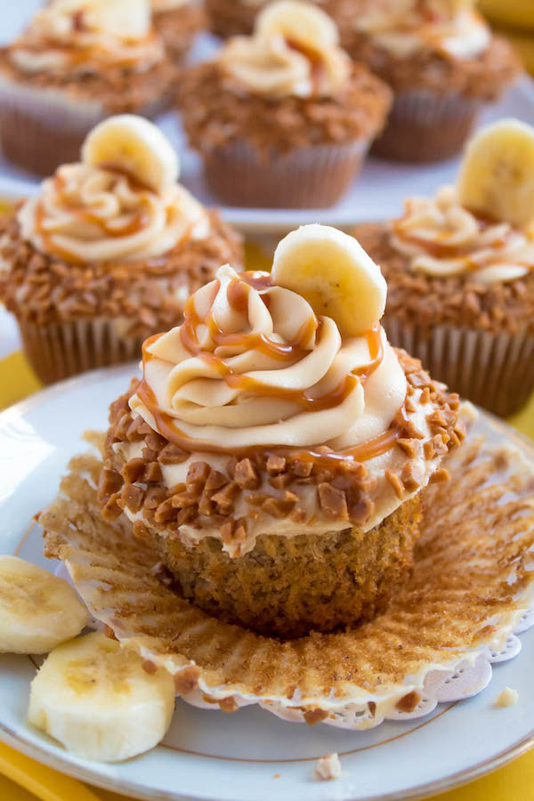 These Banana Caramel Cupcakes are moist, fluffy, tender and have the most perfect banana flavour! Filled with homemade caramel sauce, rolled in toffee bits and topped with Caramel Cream Cheese Frosting — these cupcakes will have your taste buds going crazy!