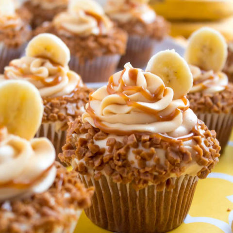 These Banana Caramel Cupcakes are moist, fluffy, tender and have the most perfect banana flavour! Filled with homemade caramel sauce, rolled in toffee bits and topped with Caramel Cream Cheese Frosting — these cupcakes will have your taste buds going crazy!