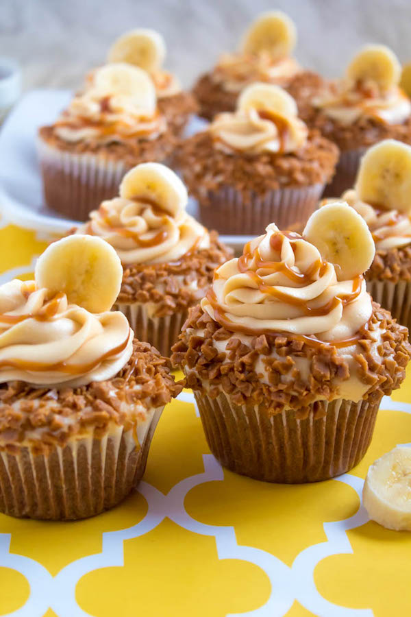 These Banana Caramel Cupcakes are moist, fluffy, tender and have the most perfect banana flavour! Filled with homemade caramel sauce, rolled in toffee bits and topped with Caramel Cream Cheese Frosting — these cupcakes will have your taste buds going crazy!
