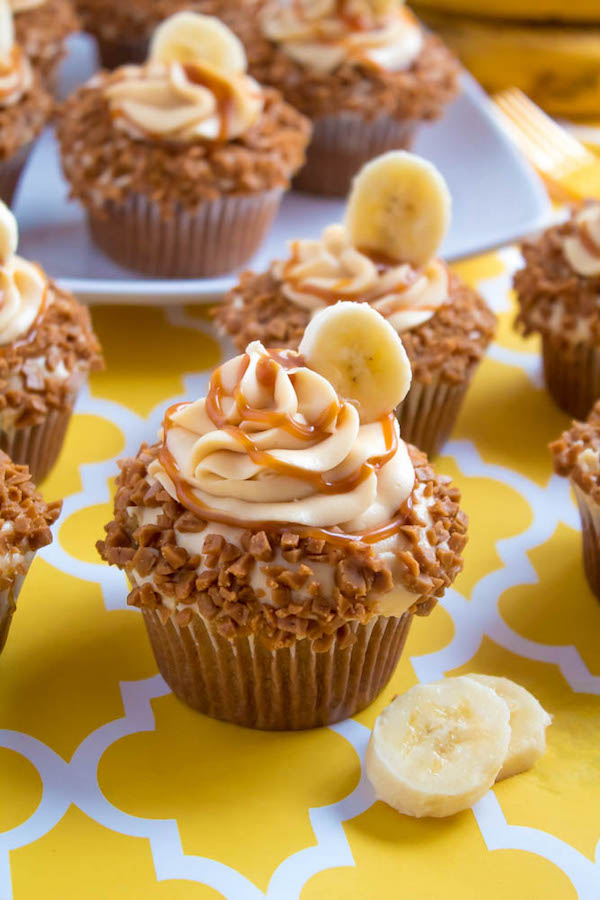 These Banana Caramel Cupcakes are moist, fluffy, tender and have the most perfect banana flavour! Filled with homemade caramel sauce, rolled in toffee bits and topped with Caramel Cream Cheese Frosting — these cupcakes will have your taste buds going crazy!