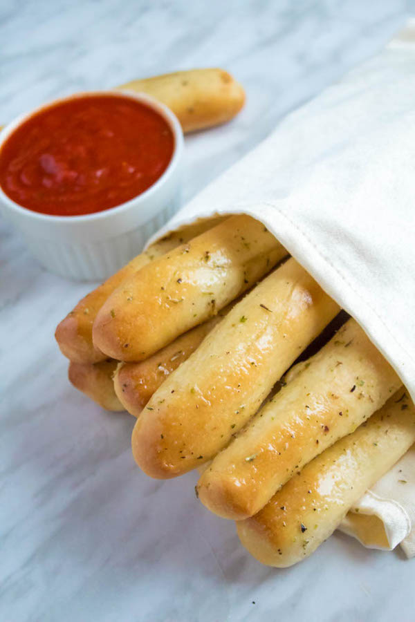 These Homemade Garlic Butter Breadsticks are incredibly soft, fluffy and buttery. They're so simple to make and are a great addition to all your meals!