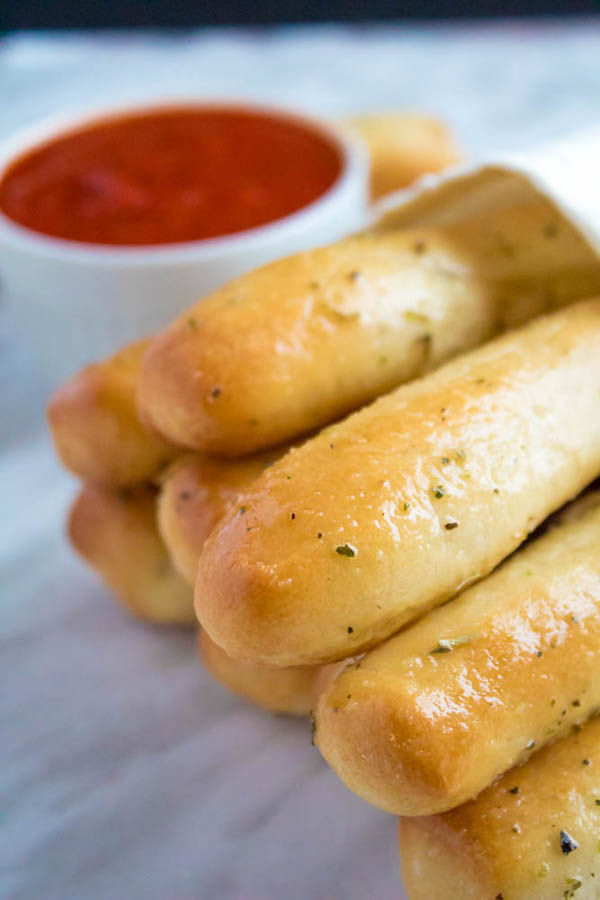 These Homemade Garlic Butter Breadsticks are incredibly soft, fluffy and buttery. They're so simple to make and are a great addition to all your meals!