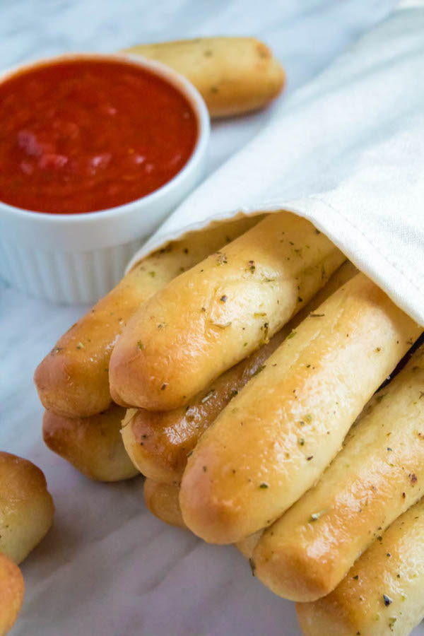 These Homemade Garlic Butter Breadsticks are incredibly soft, fluffy and buttery. They're so simple to make and are a great addition to all your meals!