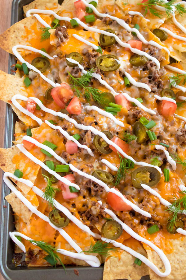 These tasty Nachos are loaded with taco-seasoned ground beef, jalapeños, 2 different cheeses and so much more! Serve them at your Superbowl party, movie night, or any occasion!