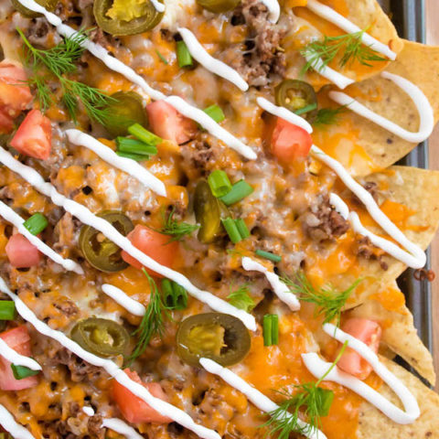 These tasty Nachos are loaded with taco-seasoned ground beef, jalapeños, 2 different cheeses and so much more! Serve them at your Superbowl party, movie night, or any occasion!