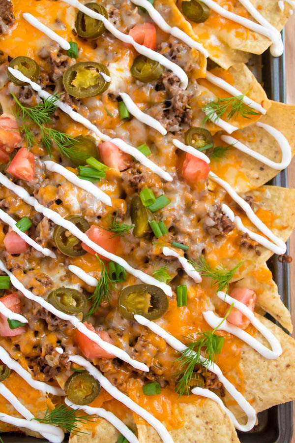 These tasty Nachos are loaded with taco-seasoned ground beef, jalapeños, 2 different cheeses and so much more! Serve them at your Superbowl party, movie night, or any occasion!