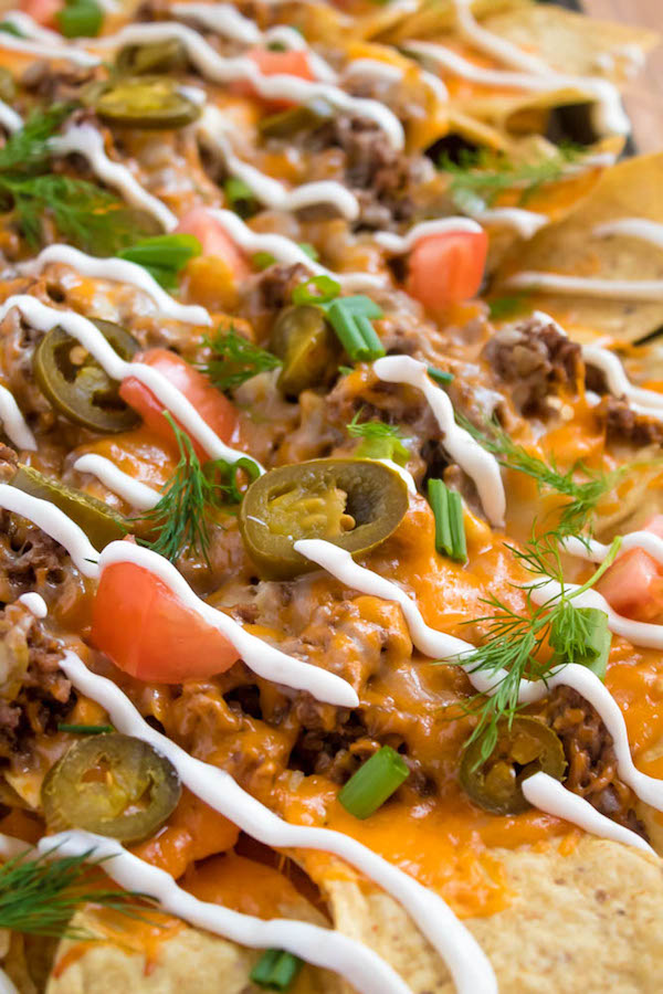 These tasty Nachos are loaded with taco-seasoned ground beef, jalapeños, 2 different cheeses and so much more! Serve them at your Superbowl party, movie night, or any occasion!