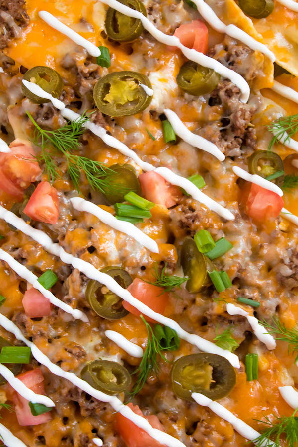These tasty Nachos are loaded with taco-seasoned ground beef, jalapeños, 2 different cheeses and so much more! Serve them at your Superbowl party, movie night, or any occasion!