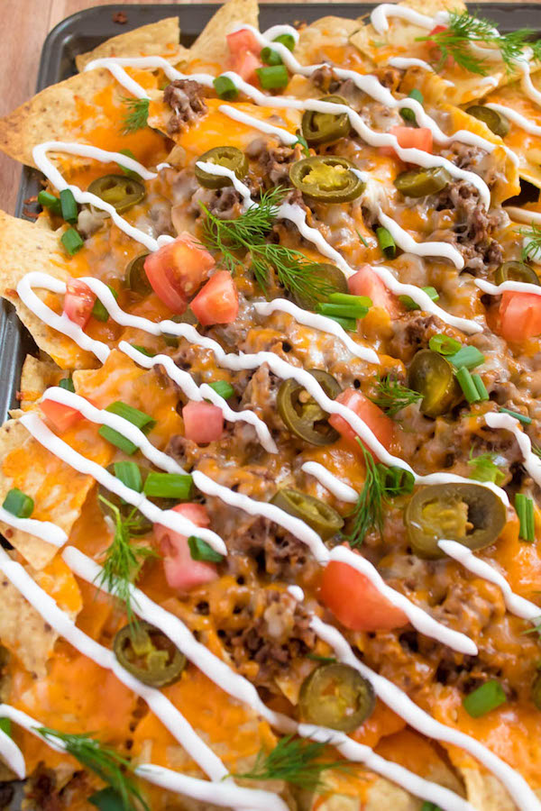 These tasty Nachos are loaded with taco-seasoned ground beef, jalapeños, 2 different cheeses and so much more! Serve them at your Superbowl party, movie night, or any occasion!