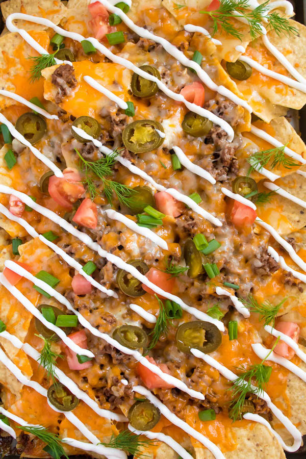 These tasty Nachos are loaded with taco-seasoned ground beef, jalapeños, 2 different cheeses and so much more! Serve them at your Superbowl party, movie night, or any occasion!