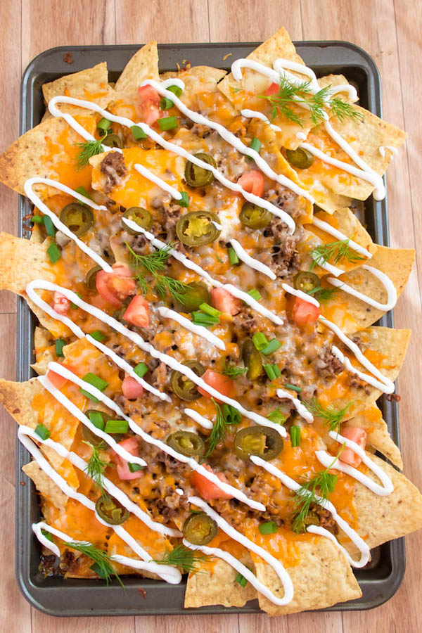 These tasty Nachos are loaded with taco-seasoned ground beef, jalapeños, 2 different cheeses and so much more! Serve them at your Superbowl party, movie night, or any occasion!