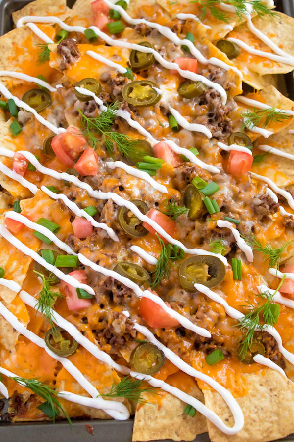 These tasty Nachos are loaded with taco-seasoned ground beef, jalapeños, 2 different cheeses and so much more! Serve them at your Superbowl party, movie night, or any occasion!