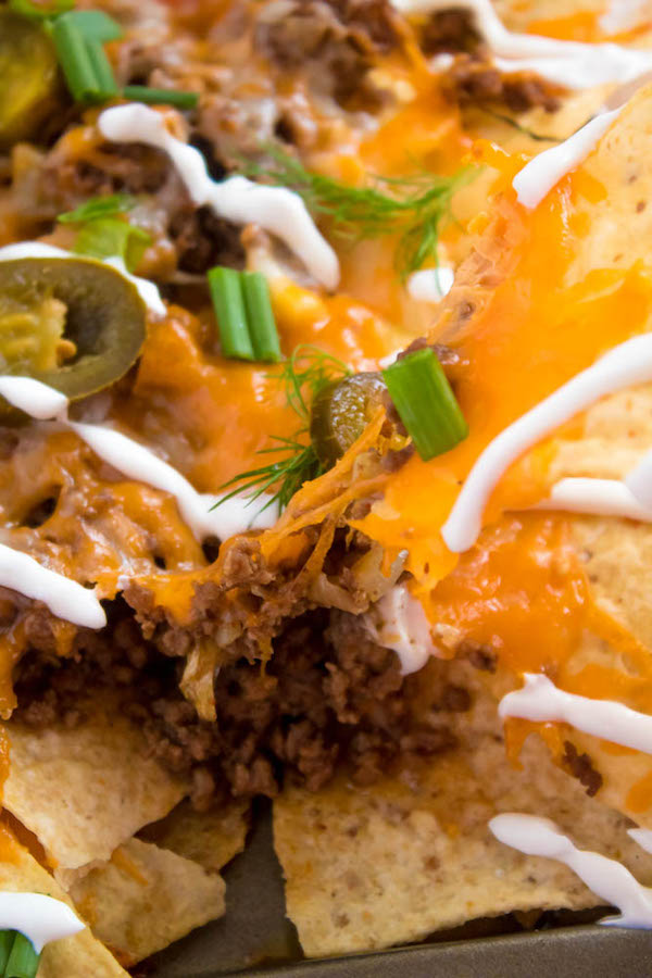 These tasty Nachos are loaded with taco-seasoned ground beef, jalapeños, 2 different cheeses and so much more! Serve them at your Superbowl party, movie night, or any occasion!