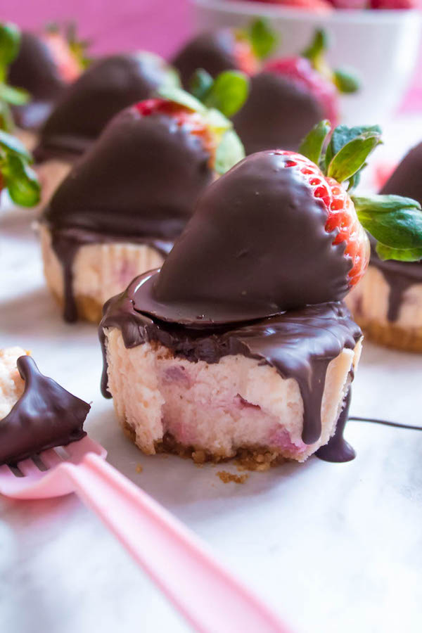 These Mini Chocolate Covered Strawberry Cheesecakes are made with a creamy bite-sized strawberry cheesecake and juicy chocolate covered strawberries. These are the perfect treats to finish off a romantic Valentine's Day dinner!