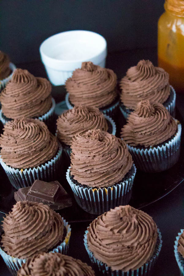 These Salted Caramel Dark Chocolate Cupcakes are made with a moist Dark Chocolate Cake, filled with Salted Caramel Sauce, topped with a rich and decadent Dark Chocolate Buttercream and a sprinkle of sea salt. They're simply irresistible!