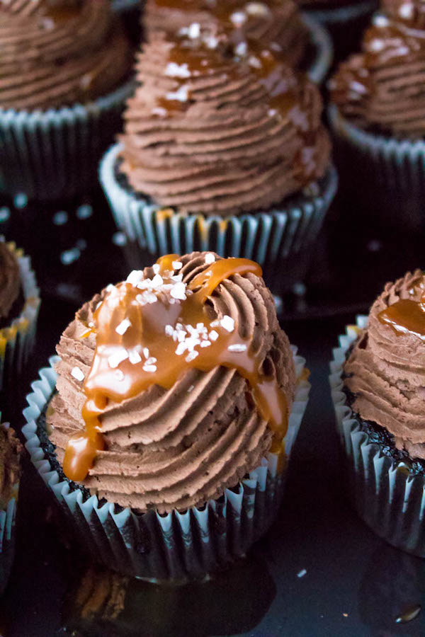 These Salted Caramel Dark Chocolate Cupcakes are made with a moist Dark Chocolate Cake, filled with Salted Caramel Sauce, topped with a rich and decadent Dark Chocolate Buttercream and a sprinkle of sea salt. They're simply irresistible!