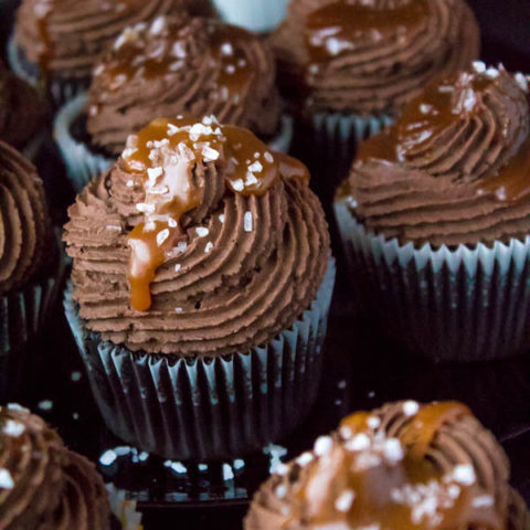 These Salted Caramel Dark Chocolate Cupcakes are made with a moist Dark Chocolate Cake, filled with Salted Caramel Sauce, topped with a rich and decadent Dark Chocolate Buttercream and a sprinkle of sea salt. They're simply irresistible!