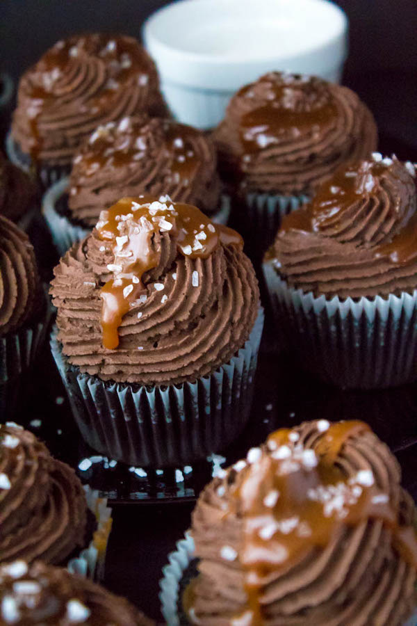 These Salted Caramel Dark Chocolate Cupcakes are made with a moist Dark Chocolate Cake, filled with Salted Caramel Sauce, topped with a rich and decadent Dark Chocolate Buttercream and a sprinkle of sea salt. They're simply irresistible!