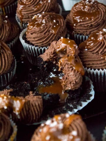 These Salted Caramel Dark Chocolate Cupcakes are made with a moist Dark Chocolate Cake, filled with Salted Caramel Sauce, topped with a rich and decadent Dark Chocolate Buttercream and a sprinkle of sea salt. They're simply irresistible!